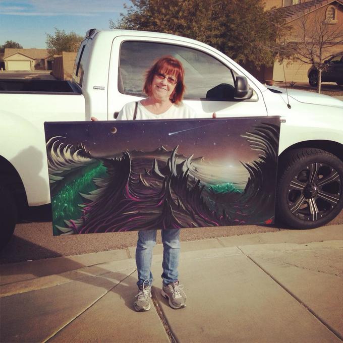 Karen holding one of Joey's paintings