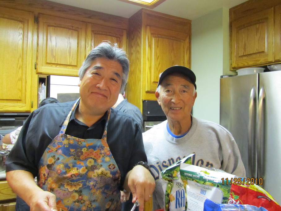 Carl and Steve carving turkey for Thanksgiving