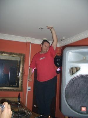 Paul touching the sky during a DJ set