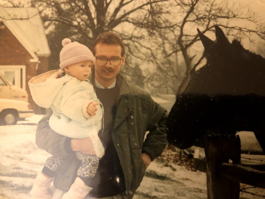 Mike and his daughter feeding the horses