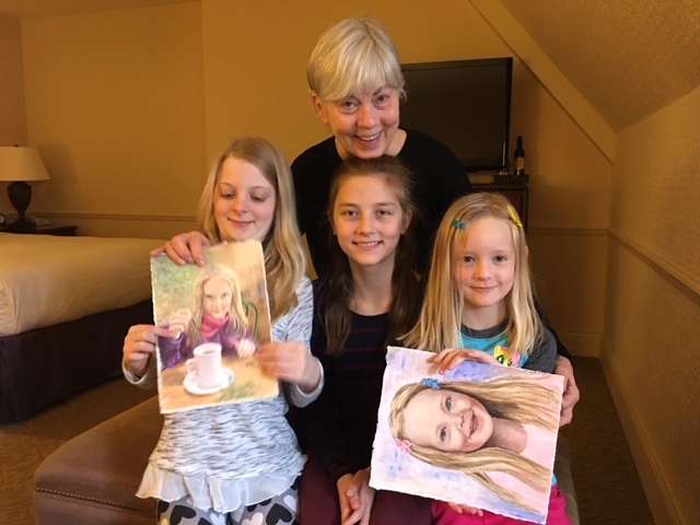 Ann with watercolor portraits (and their subjects)