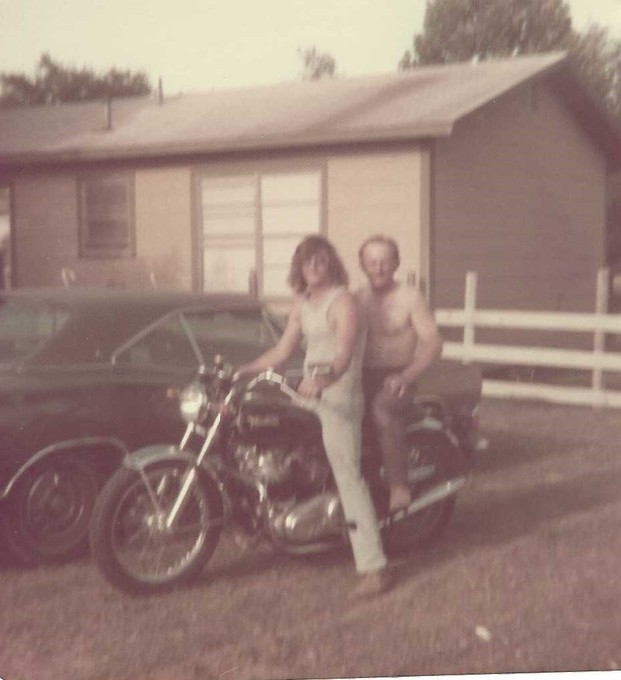 Bobby and Dad riding his motorcycle.