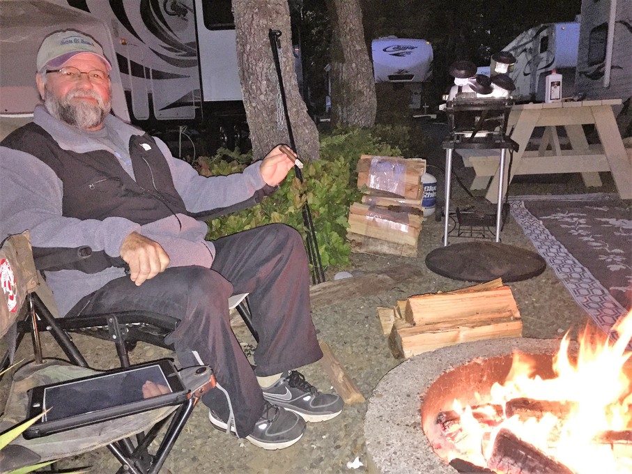 Pop enjoying a cigar by a fire in Oregon 2015