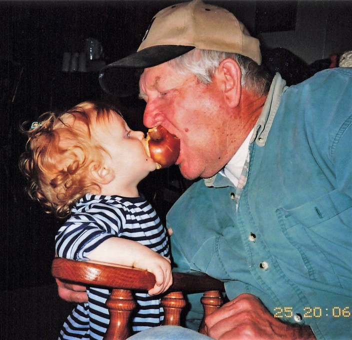 Grandpa Howard sharing an apple with, now 18 year old, granddaughter Kendra Branch