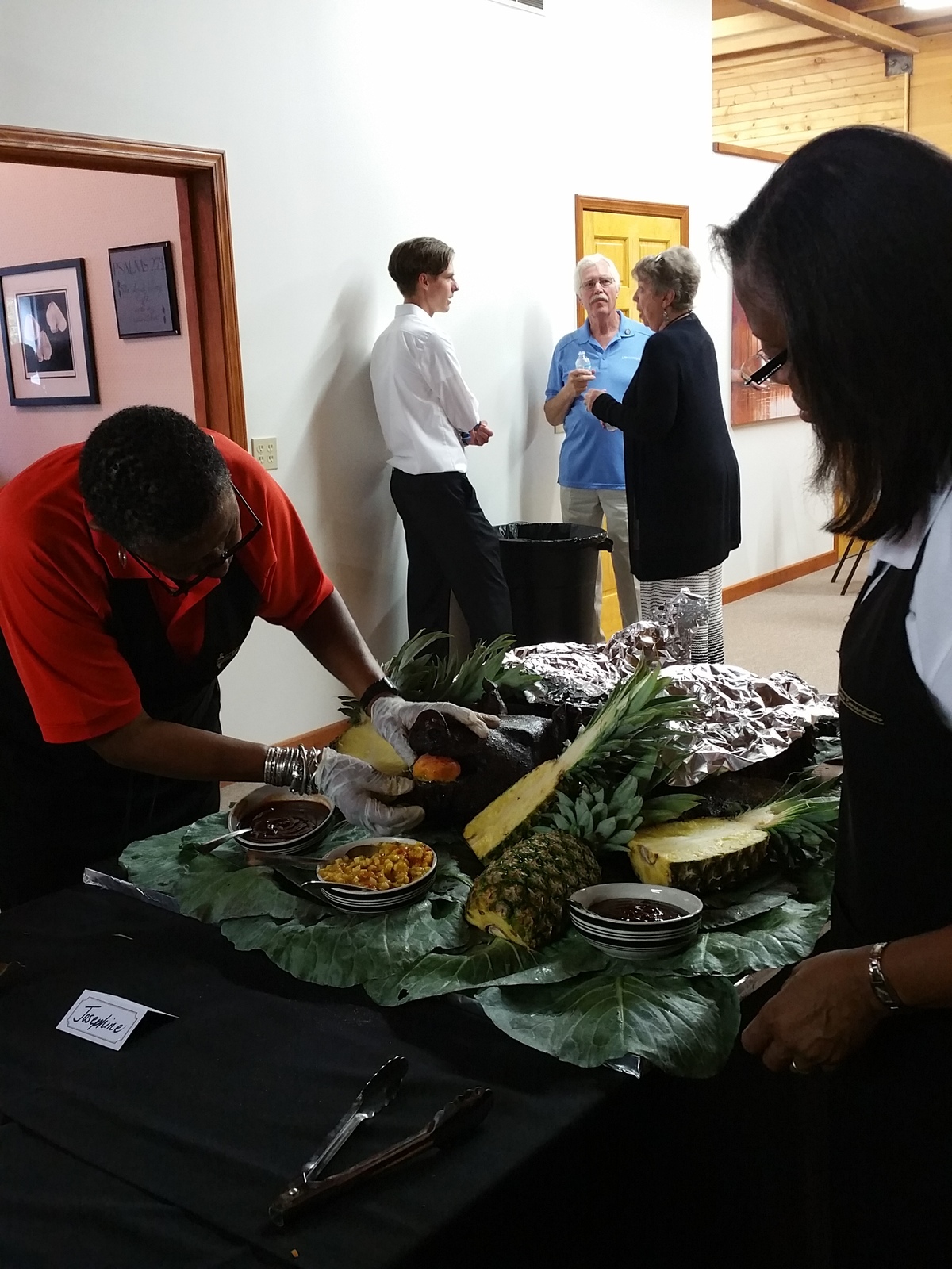 Donna putting the final touch on Josephine, a slow roasted whole pig for her nephew, Jacob.